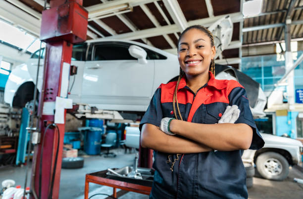 istock Engineer team checking under car condition on lifter in garage.Young auto mechanic in uniform is looking at camera and smiling examining car. 1471646973