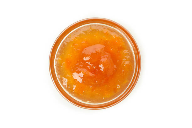 istock Bowl of peach jam isolated on white background 1471650366