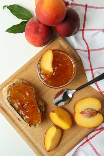 istock Peach jam, sandwich with peach jam and ingredients on white background 1471650392