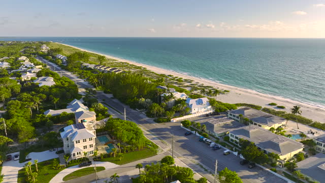 View from above of large residential houses in island small town Boca Grande on Gasparilla Island in southwest Florida. American dream homes as example of real estate development in US suburbs