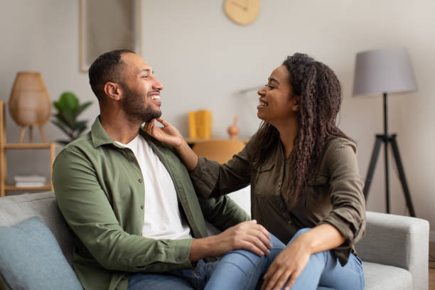 istock Happy Black Couple Sitting And Hugging At Home 1471651315