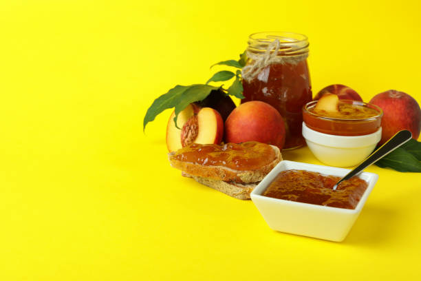 istock Peach jam and ingredients on yellow background 1471651847