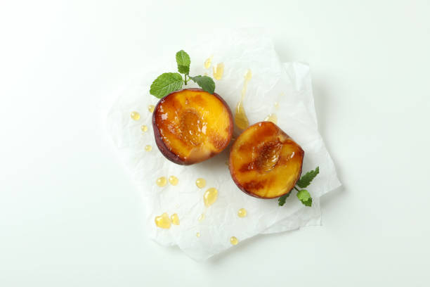 istock Grilled peach with honey on white background 1471653102