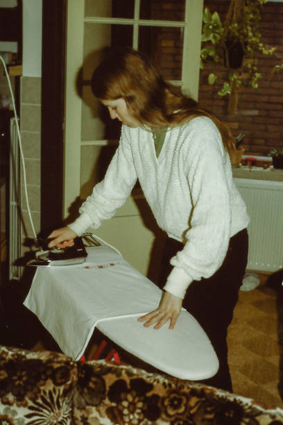 istock Ironing Young woman back in the seventies 1471655680
