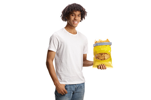 Young african american man holding a pack of tortilla chips isolated on white background