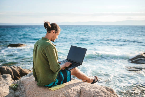 istock Young digital nomad man working by the sea 1471657494