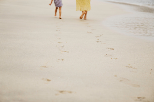 Footprints on the sandy coast of the sea. Relaxation concept. Background, soft light, front view