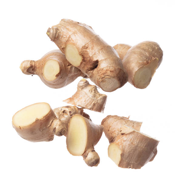 istock Ginger fall fly in mid air, fresh vegetable spice ginger falling. Organic fresh herbal ginger root head cut chop slice, close up texture. White background isolated freeze motion high speed shutter 1471659738