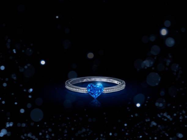 istock Diamond ring Blue Heart shaped. on black background with abstract lights. 3d render 1471660605