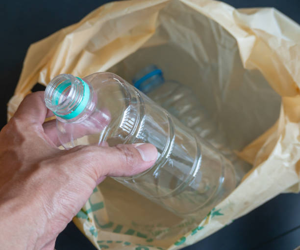 istock Human hands (body parts) holding a water bottle are being thrown into plastic. 1471661354