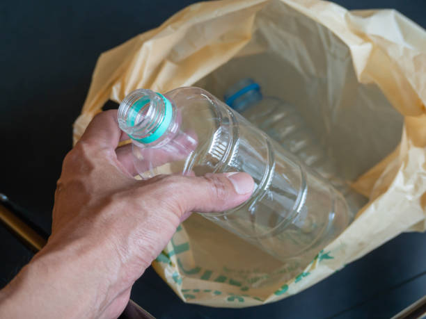 istock Human hands (body parts) holding a water bottle are being thrown into plastic. 1471661372