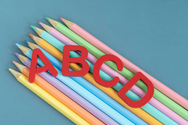 istock Back to school concept with assorted letters and colored pencils in pastel colors 1471662547