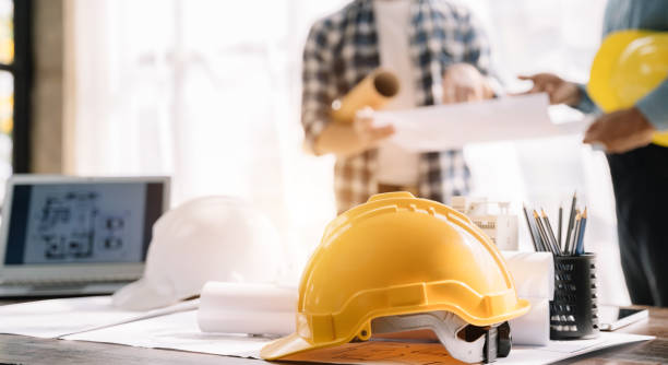 istock Engineer teams meeting working together wear worker helmets hardhat on construction site. Industry professional team. 1471662676