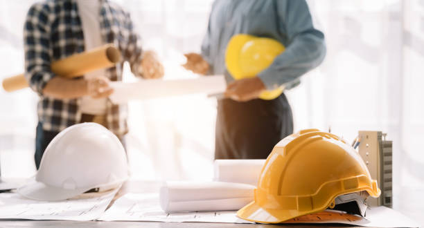 istock Engineer teams meeting working together wear worker helmets hardhat on construction site. Industry professional team. 1471662694