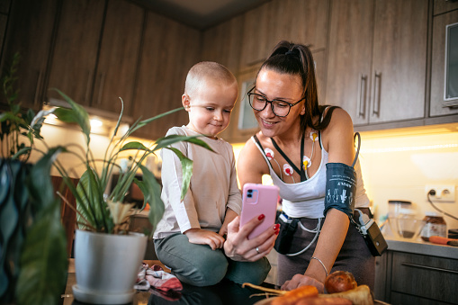 woman wearing holter monitor device continues her normal life at home