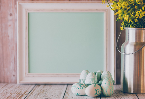 Horizontal picture frame mockup. Happy Easter farmhouse theme SVG craft product mockup styled with wooden bunnies and pastel eggs against a white wood background.