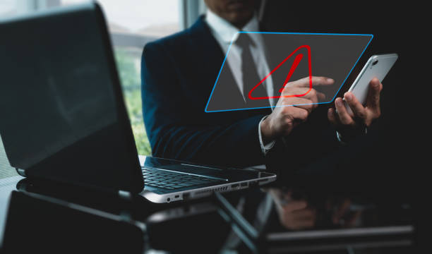 istock Exclamation alarm caution warning notice mark sign, computer virus detected, personal data protection, and network security concept are displayed for a businessman using a laptop at the office. 1471665068