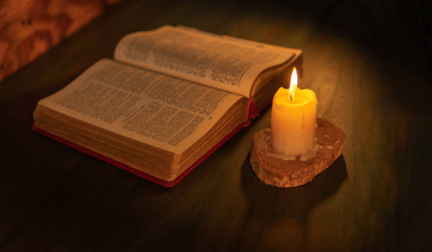 istock Bible illuminated by candlelight on a wooden table 1471666887