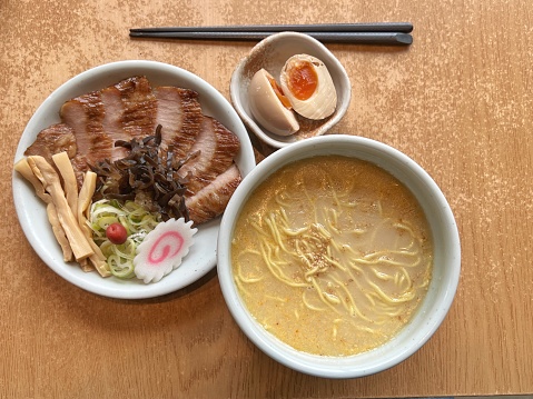 Overhead view of a set of Japanese Shio flavor Santouka Ramen served with Roasted Pork Cheeks and Tamago