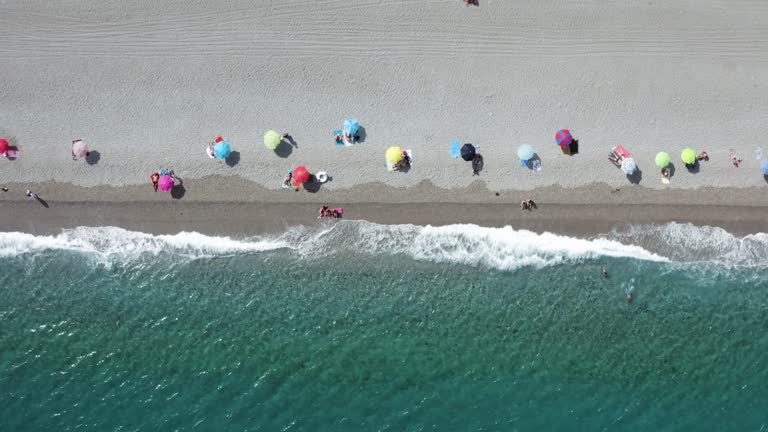 Aerial view of people on the beach in summertime, Sicily, Italy.