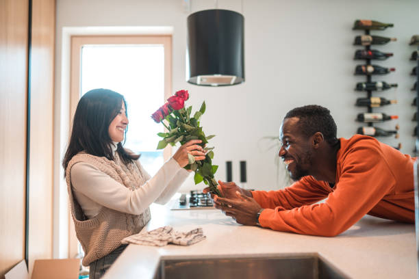 istock Black Male Surprising Asian Girlfriend With A Bouquet 1471670413