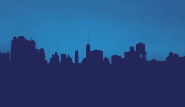 New York City skyline buildings form silhouette shapes against the background sky in Manhattan with blue monotone colors