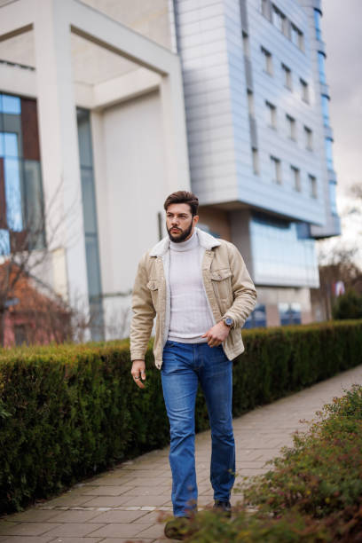 istock Young handsome man walking in the city 1471672621