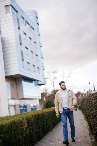 istock Young handsome man walking in the city 1471672673