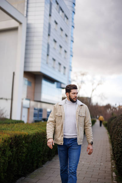 istock Young handsome man walking in the city 1471672716