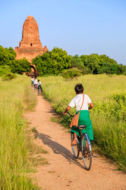 istock Burmese school children riding a bicycle in Bagan, Myanmar 1471673499