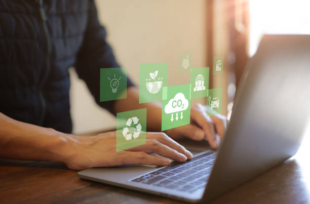 istock Reduce CO2 emission concept. Businessman use laptop computer with environment icon. technology Net zero and Carbon neutrality, green business and development based on renewable energy. Climate Change, 1471673524