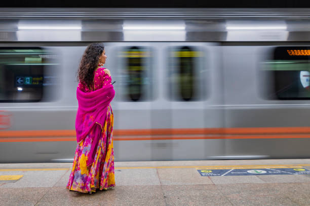 istock Indian girl using a mobile phone at metro station, India 1471674862