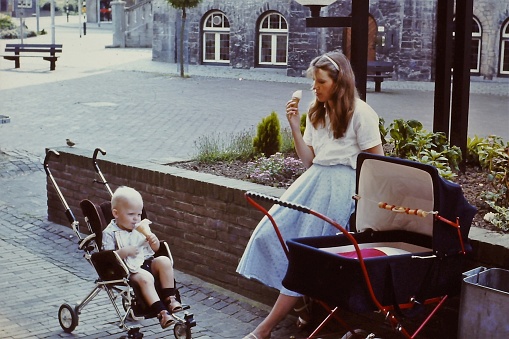 Young mother having a Ice Cream break during  a walk with there  baby's.