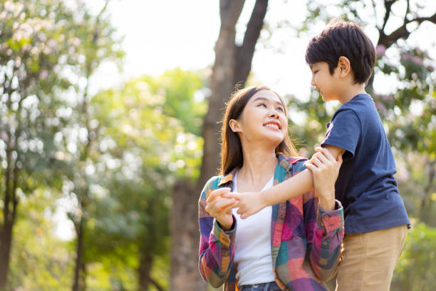 istock Mother and son playing in the park. 1471676366