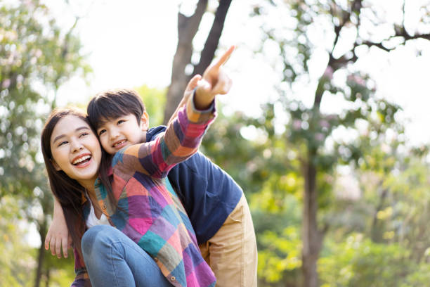 istock Mother and son playing in the park. 1471676387