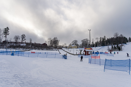 People skiing at the Messila Ski Resort in winter. Hollola, Finland. February 7, 2023.