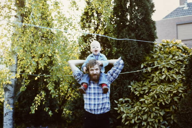 молодой отец в восьмидесятые год�ы с сыном - 1970s style фотографии стоковые фото и изображения