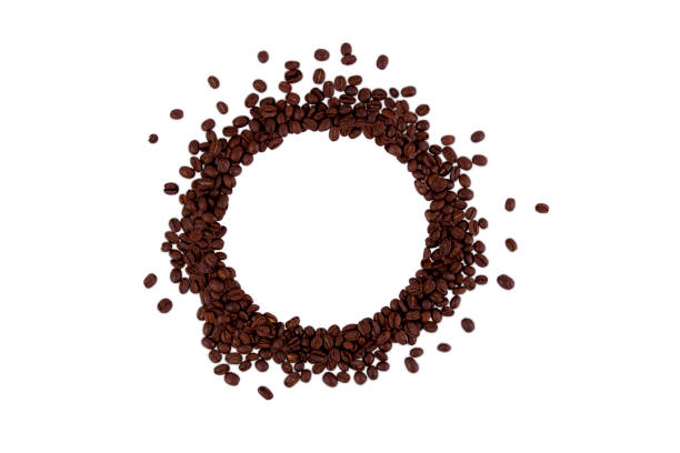 istock Roasted coffee beans isolated on a white background with copy space in the center. 1471677329
