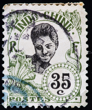 Portrait of a woman on an old postage stamp from French Indochina.