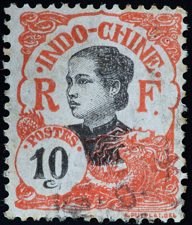 Portrait of a woman on an old postage stamp from French Indochina.