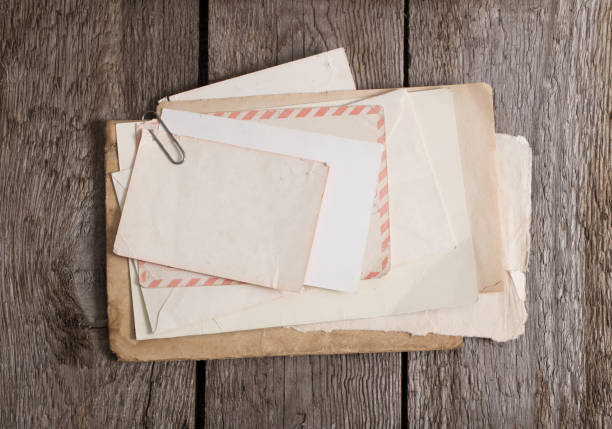 istock old paper on wooden background 1471678719