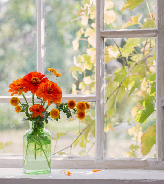 istock flowes in green glass vase on windowsill 1471678880