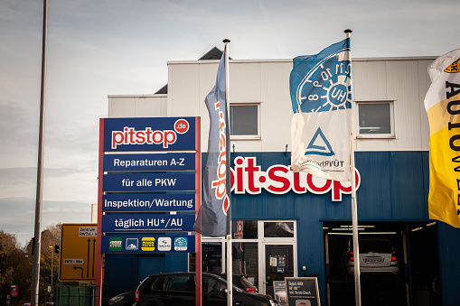 Picture of a sign with the logo of Pitstop on their main store for Aachen, Germany. Pitstop.de GmbH is a Germany-wide company in the automotive industry that carries out repairs, maintenance and repairs on motor vehicles of all brands according to manufacturer specifications.