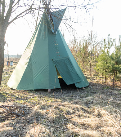 green tepee set up in garden, early spring, traditional Indian dwelling