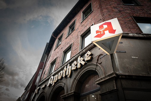 Picture of a german pharmacy in Aachen, an apotheke, with its iconic sign with the red letter A.