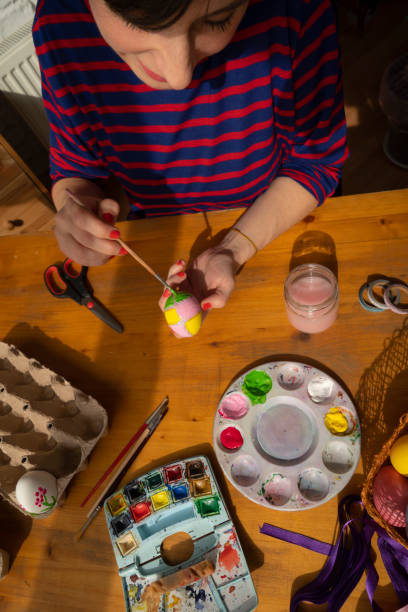 istock Woman painting Easter Egg and preparing for Easter holiday celebration 1471682867