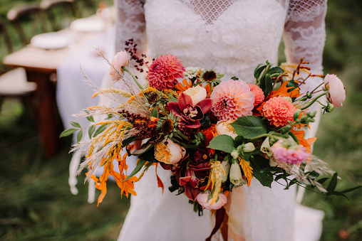 Bride holding a brightly colored floral bouquet
