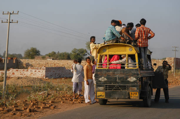 Rajasthan, India - February 27, 2006: People boarding a cargo mototaxi on the road that goes to the town of Nayla Fort