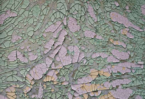 Cracked peeling old paint on a wall closeup