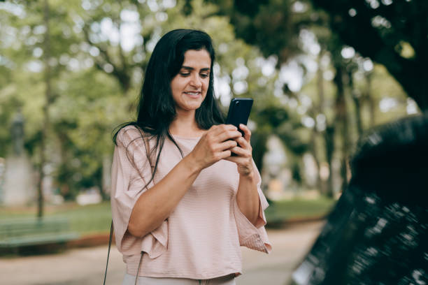 istock Woman ordering a taxi through an app 1471688574